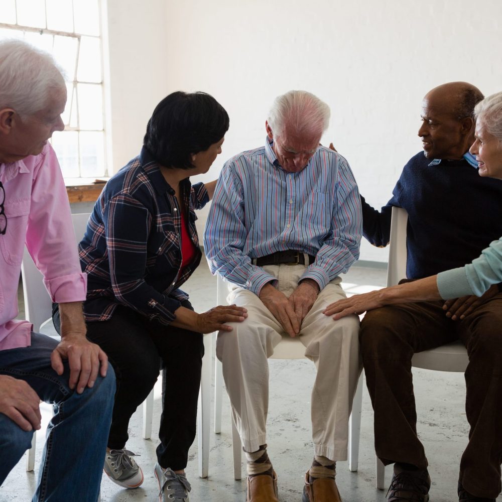 senior-friends-consoling-male-friend-2026-03-25-02-48-12-utc